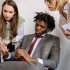 business people discussing infront of a laptop