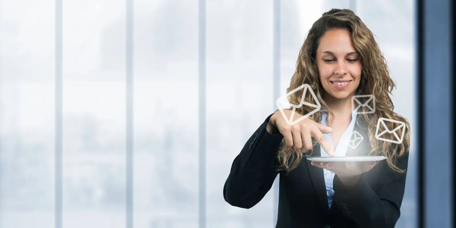 woman with laptop and email icons floating